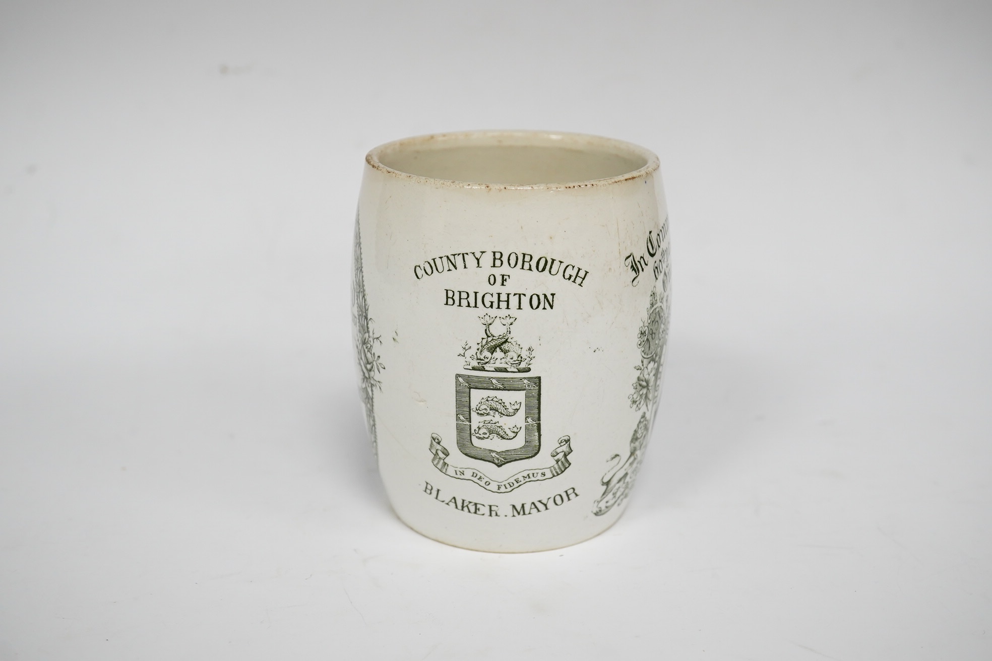 A Queen Victoria commemorative mug celebrating the 1897 Diamond Jubilee, County Borough of Brighton, 10cm high. Condition - poor